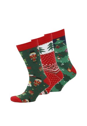 Drei Paare bunter Socken: grüne mit Nussknacker-Motiv, rote mit weißen Punkten, dunkelblaue mit Weihnachtsbäumen und -ornamenten.