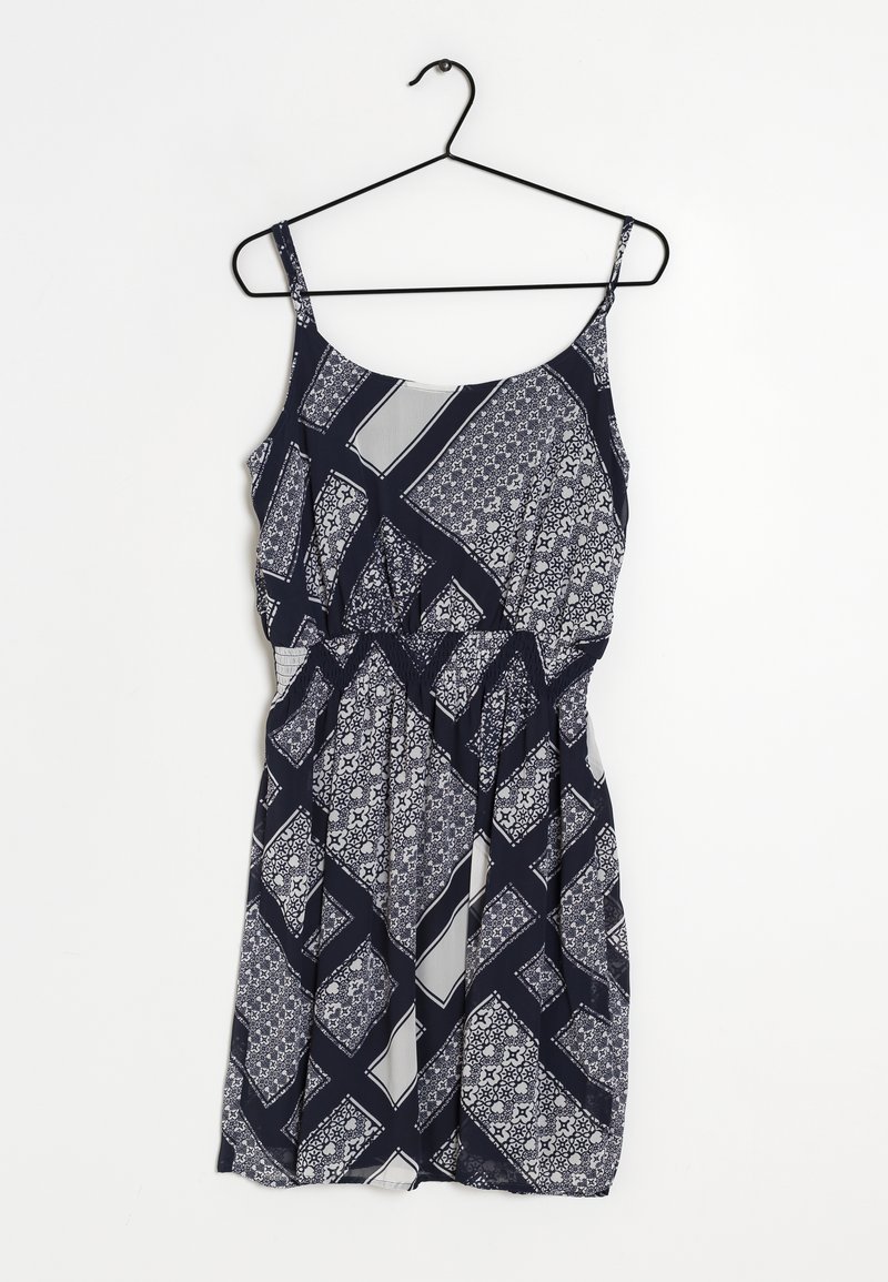 Robe bleu marine avec des motifs géométriques et floraux blancs, en tissu léger, à bretelles spaghetti et avec une taille élastique pour un bon ajustement.