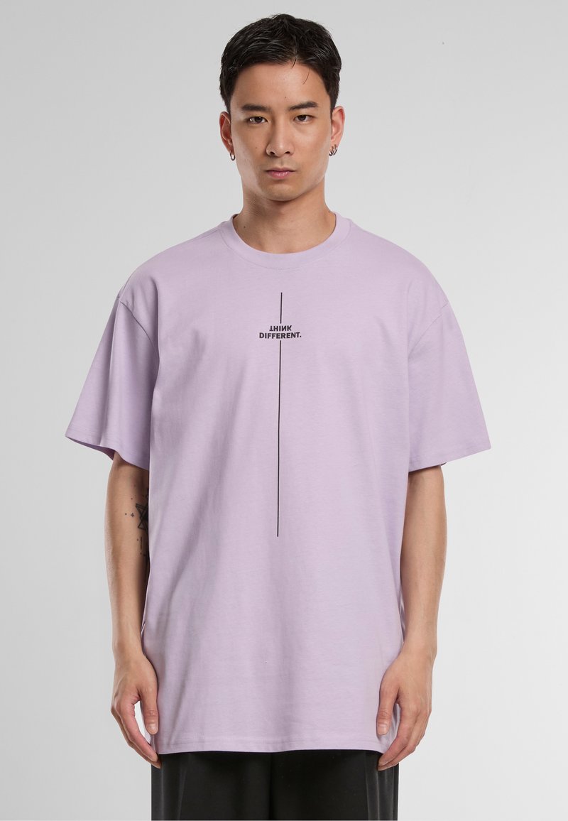 Short-sleeve lavender t-shirt in cotton, featuring black text "THINK DIFFERENT." centered vertically. Relaxed fit with dropped shoulders.