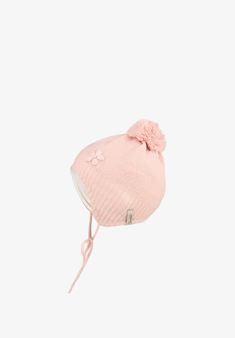 Pink knitted baby hat with pom-pom, earflaps, tie strings, and a small flower detail on the side.