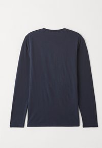 Navy blue long-sleeve t-shirt made of smooth cotton, featuring a round neck and straight hem with side slits, displayed from the back.