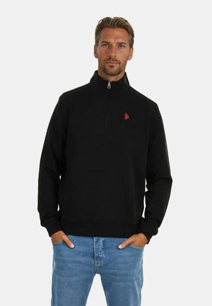 Schwarze Zip-up Sweatjacke mit Stehkragen, aus Fleece-Stoff, mit einem kleinen roten Logo auf der Brust und lässigen Ärmeln.