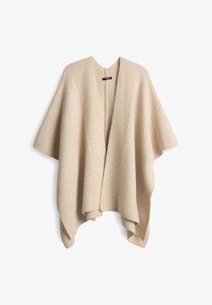 Beige open-front poncho met ribbeltextuur, brede mouwen en een ontspannen silhouet. De stof lijkt zacht en lichtgewicht. Geen sluitingen zichtbaar.