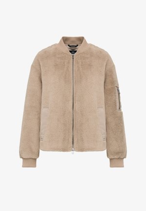 Beige Bomberjacke aus Kunstfell mit Frontreißverschluss, geripptem Kragen und Bündchen, zwei Seitentaschen und einer Reißverschlusst Tasche am linken Ärmel.