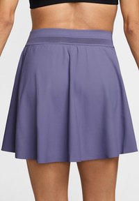 Paarse sportrok met een brede, elastische tailleband en een vloeiende, geplooide ontwerp. Glad textuur, boven de knie lengte, geschikt voor sportkleding.