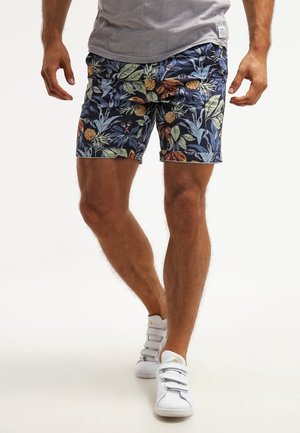 Herresvømmebukser med en marineblå base, prydet med et blomsterprint i grønne og orange toner. Fremstillet af letvægtsstof, med sidelommer.