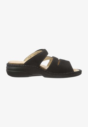 Black sandal with two crossed straps, made of a soft material. Features a textured footbed and a sturdy black sole.