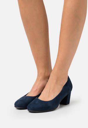 Navy blue suede high heel shoes with a rounded toe and a block heel. The texture is soft and smooth, featuring a simple, classic design.