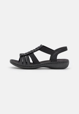 Sandale noire à bout ouvert avec détail de bride tressée, supports latéraux élastiques et semelle rembourrée, conçue pour un usage décontracté.