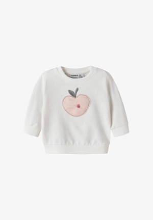 Baltas kūdikio džemperis su ilgomis rankovėmis, priekyje rausvai siuvinėtas obuolys su pilka lapelio detale.