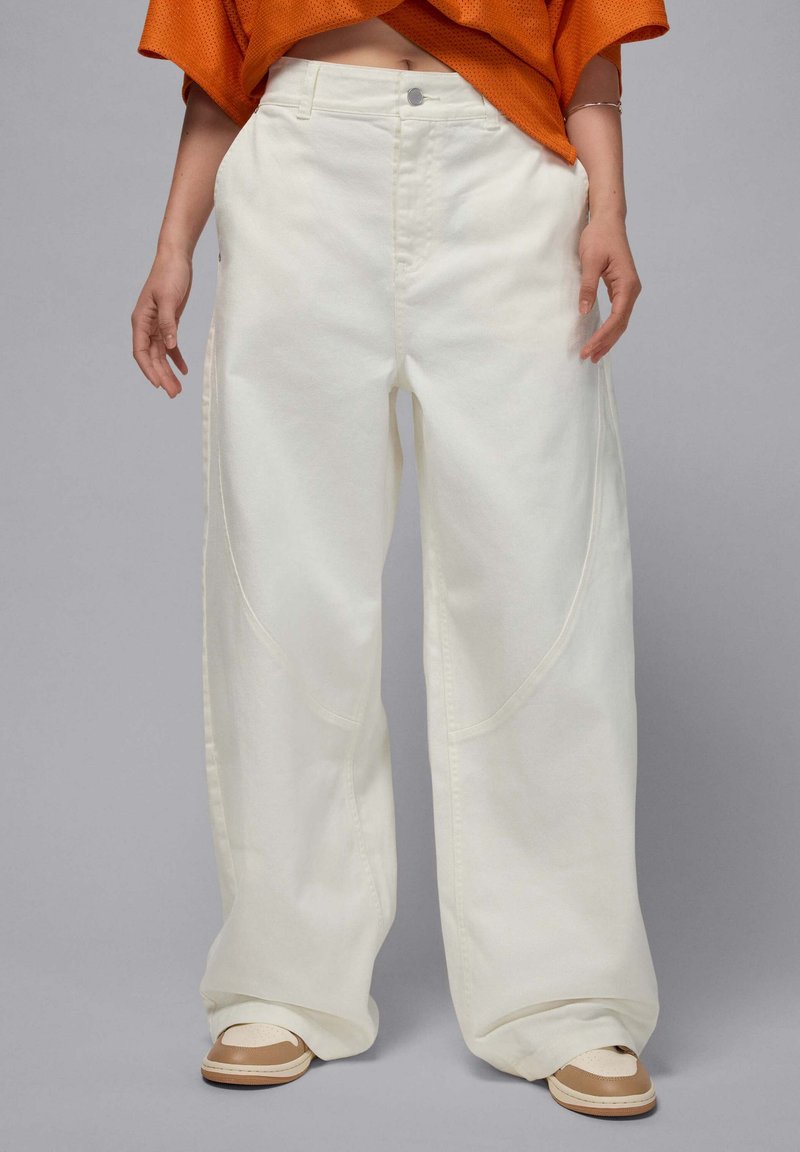Wide-leg white denim pants with side pockets and a straight cut design, featuring a button closure and contrasting stitching details.