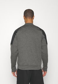 Nike Performance THERMA NOVELTY BOMBER - Chaqueta de entrenamiento - charcoal heather black/black