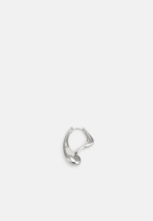 Silver-toned, sculptural hoop earring with a smooth, reflective surface and an abstract, curved shape on a white background.