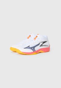 White athletic shoes with orange accents, black logo, and multi-colored sole featuring pink and yellow. Mesh upper with a textured finish.