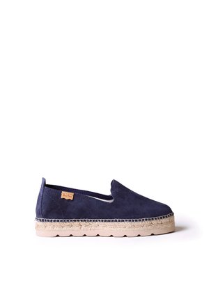 Navy suede espadrille with a jute sole, elastic side panel, and a small branded tag on the outer side. Simple design, casual style.