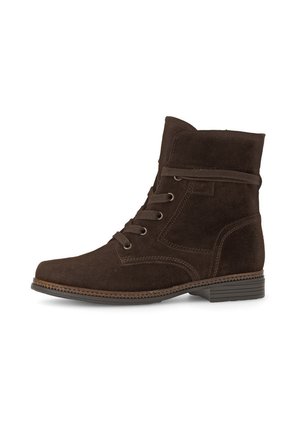 Brown suede ankle boot with a round toe, lace-up front, a decorative strap, and textured detailing near the sole. Flat heel.