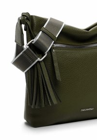 Olive green leather handbag with a textured finish, featuring a zip closure, detachable strap, and side tassel detail.
