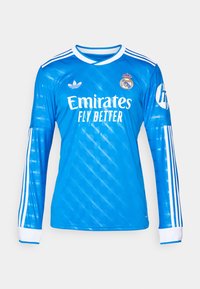 Blue long-sleeve Adidas soccer jersey with white stripes, Real Madrid crest, Emirates Fly Better sponsor, and HP logo on the sleeve.