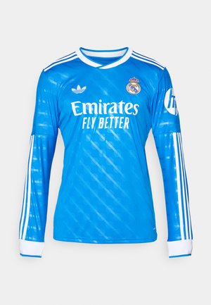 Sininen pitkähihainen Adidas-jalkapallojersey, jossa on valkoiset raidat, Real Madridin vaakuna, Emirates Fly Better -sponsori ja HP-logo hihassa.
