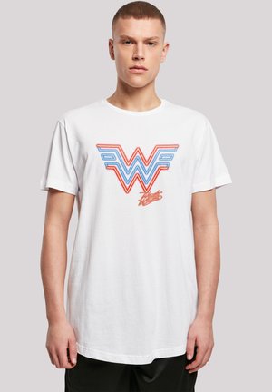 White cotton t-shirt featuring a multi-colored "W" graphic in red and blue, with bold lines and a relaxed fit. Short sleeves.