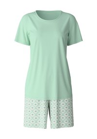 Helles grünes Baumwolloberteil mit kurzen Ärmeln, kombiniert mit gemusterten Shorts mit einem mint- und weißen Blumenmuster. Weicher Stoff, lässige Passform.