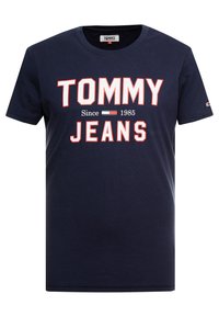 Navy blue cotton t-shirt featuring bold red and white "TOMMY JEANS" text and logo, with a crew neck and short sleeves.