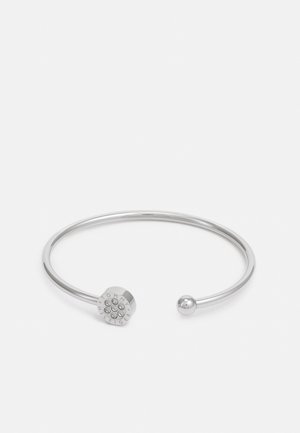 Silver cuff bracelet with a spherical end and hexagonal detail featuring embedded stones. Minimalist design, smooth texture.