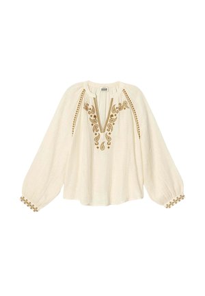 Blouse crème avec un décolleté en V, motifs floraux brodés marron et manches froncées. Présente des accents décoratifs aux poignets.