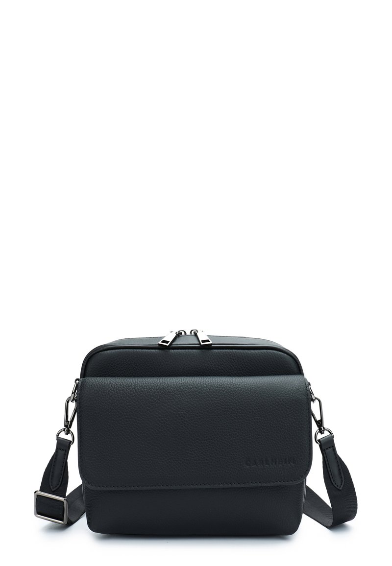 Black leather crossbody bag with a textured finish, zippered top closure, adjustable strap, and subtle branding on the front.