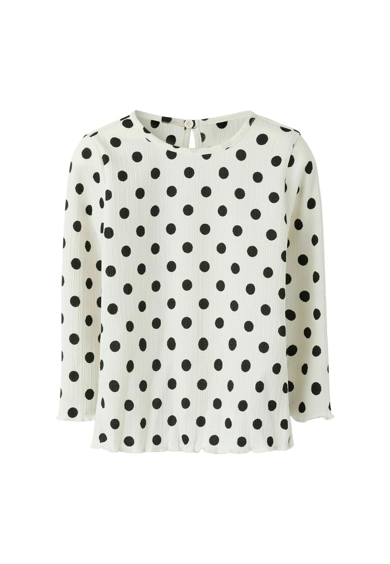 Zwarte stippen op een witte achtergrond, lange mouwen, ribbelstructuur, ronde halslijn met een kleine knoop en sleutelgatopening op de achterkant.
