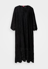 Robe midi en dentelle noire avec manches trois-quarts, motifs œillets et floraux, encolure ronde et petit détail noué à l'avant.