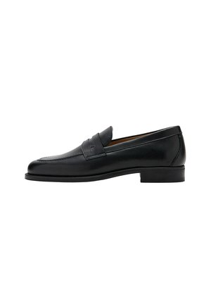 Mocasin penny de cuero negro con tacón bajo, puntera redondeada y una correa sobre la parte superior del zapato.