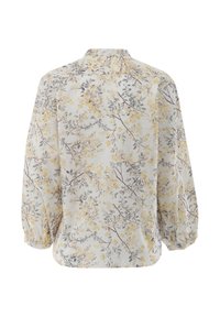 Floral blouse in light fabric with a yellow and gray floral pattern, featuring a round collar and gathered long sleeves.