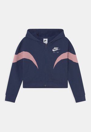 Sudadera corta navy con diseño de olas rosa, cierre de cremallera y logo en la parte frontal. Tejido suave con capucha, mangas largas y puños acanalados.