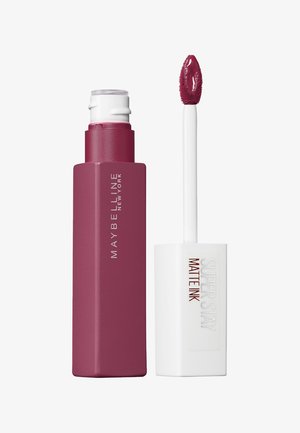 Płynna pomadka Maybelline Super Stay Matte Ink w głębokim odcieniu mauve. Posiada matowe wykończenie, prostokątną opakowanie oraz spiczasty aplikator.