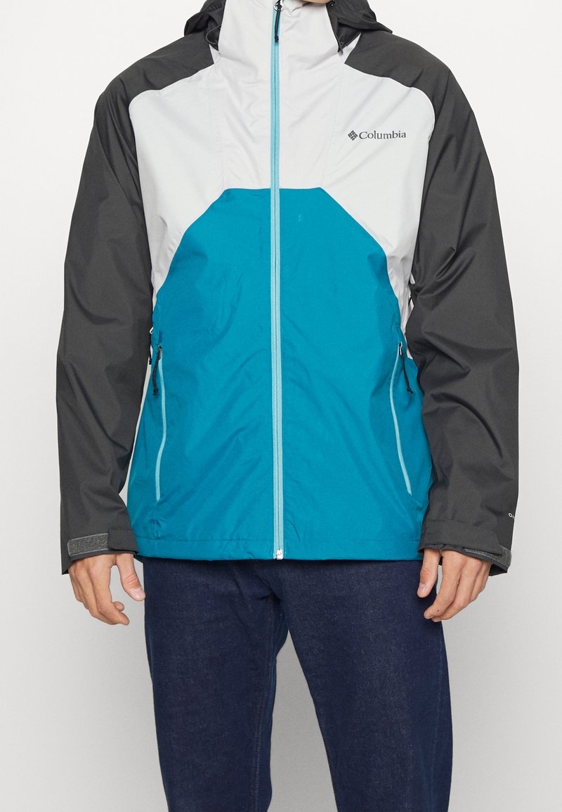 Water-resistant jacket featuring a teal front, gray sleeves, and a white upper section. Includes a zipper closure and side pockets.