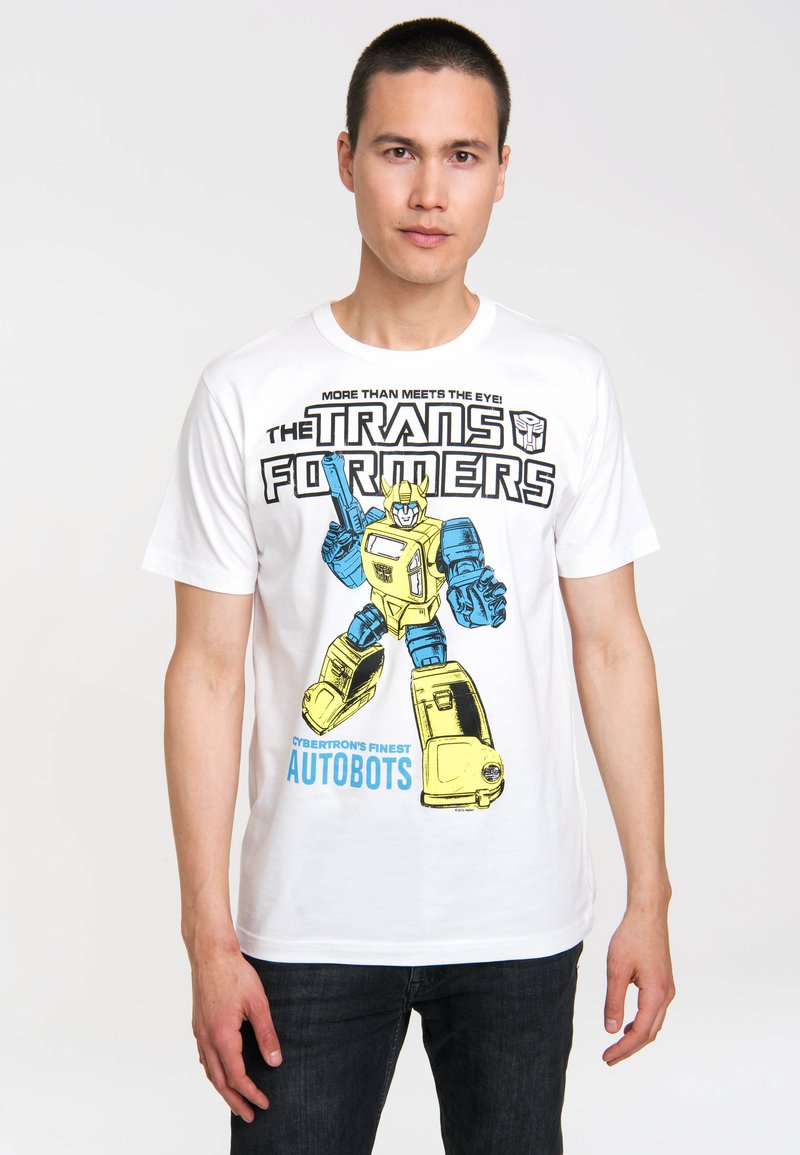 White cotton t-shirt featuring a yellow and blue graphic of a robot with the text "TRANSFORMERS" and "CYBERTRON'S FINEST AUTOBOTS."