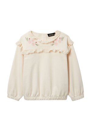 Blouse crème à manches longues avec volants en dentelle sur le yoke et le col, fleurs roses brodées et feuilles vertes, poignets et ourlet élastiques.