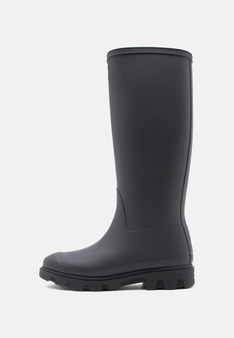 Black rubber knee-high boot with a smooth texture, rounded toe, and rugged sole featuring deep treads for traction.