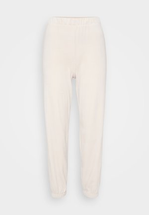 Lys beige joggebukser med elastisk midje og mansjetter. Laget av mykt stoff, med en avslappet passform og glatt tekstur.