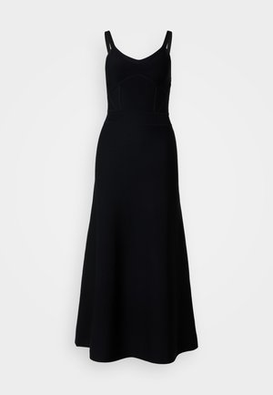 Must mustriga kleit, millel on liibuv rinnaosa ja laienev seelik. Omab V-kaelust ja õhukesi rihmasid, valmistatud siledast kangast, millel on õrn tekstuur.