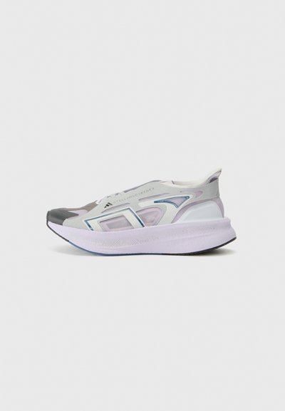 Gray and white sneaker featuring a translucent upper, unique cutouts, pastel accents, a thick white sole, and black rubber outsole.