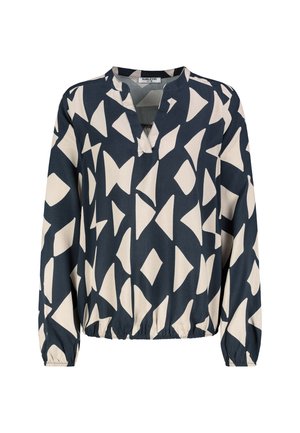 Marineblaue Bluse mit abstraktem cremefarbenem Muster, V-Ausschnitt, langen Ärmeln und elastischem Saum. Glatte Stofftextur.