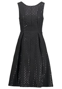 Robe noire sans manches avec un corsage ajusté et une jupe évasée, présentant un motif de points circulaires brillants sur tout le tissu.