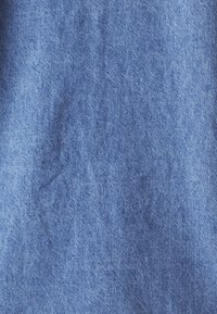 Blue denim fabric with a subtle texture, featuring a consistent weave pattern and soft finish, suitable for clothing or upholstery.