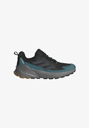 Men’s hiking shoes in black with teal accents. Lightweight mesh upper, sturdy rubber sole, and textured grip pattern. Gore-Tex waterproofing.