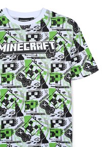 T-shirt in cotone con una base bianca e motivi grafici a tema Minecraft in nero, verde e grigio, e un logo "MINECRAFT" in evidenza.