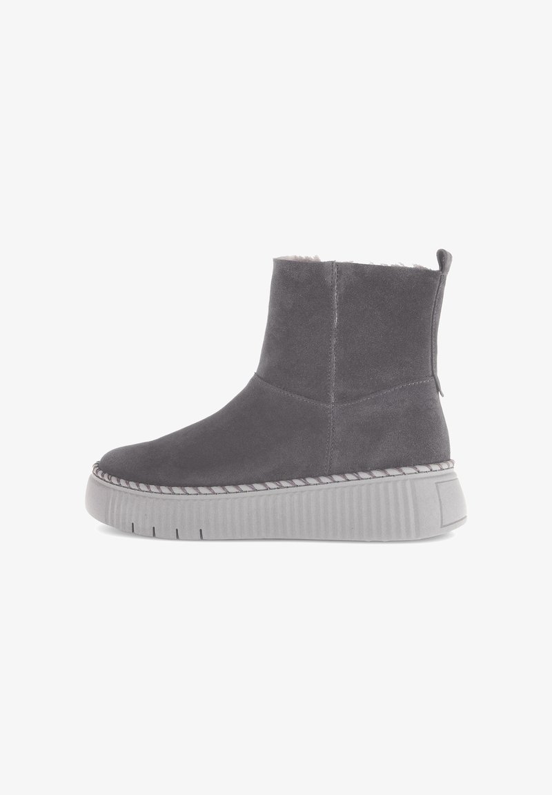 Grijze suede enkellaars met een ronde neus, contrasterende witte stiksels en een dikke, gestructureerde grijze plateauzool. Inclusief een trekriempje.