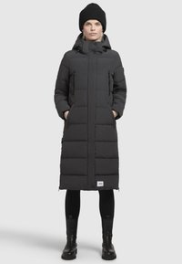 Black puffer coat with a long silhouette, two side pockets, high collar, and hood. Features a smooth texture and a square quilting pattern.