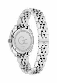 Srebrny zegarek ze stali nierdzewnej z prostokątną kopertą i metalową bransoletą. Posiada szafirowe szkło oraz grawerowane detale na tylnej części.